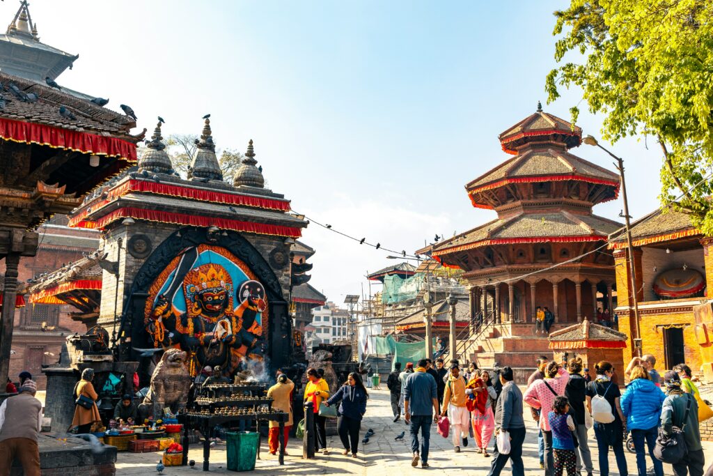 Dense urban landscape of Kathmandu, Nepal, with colorful buildings closely packed together across the city.